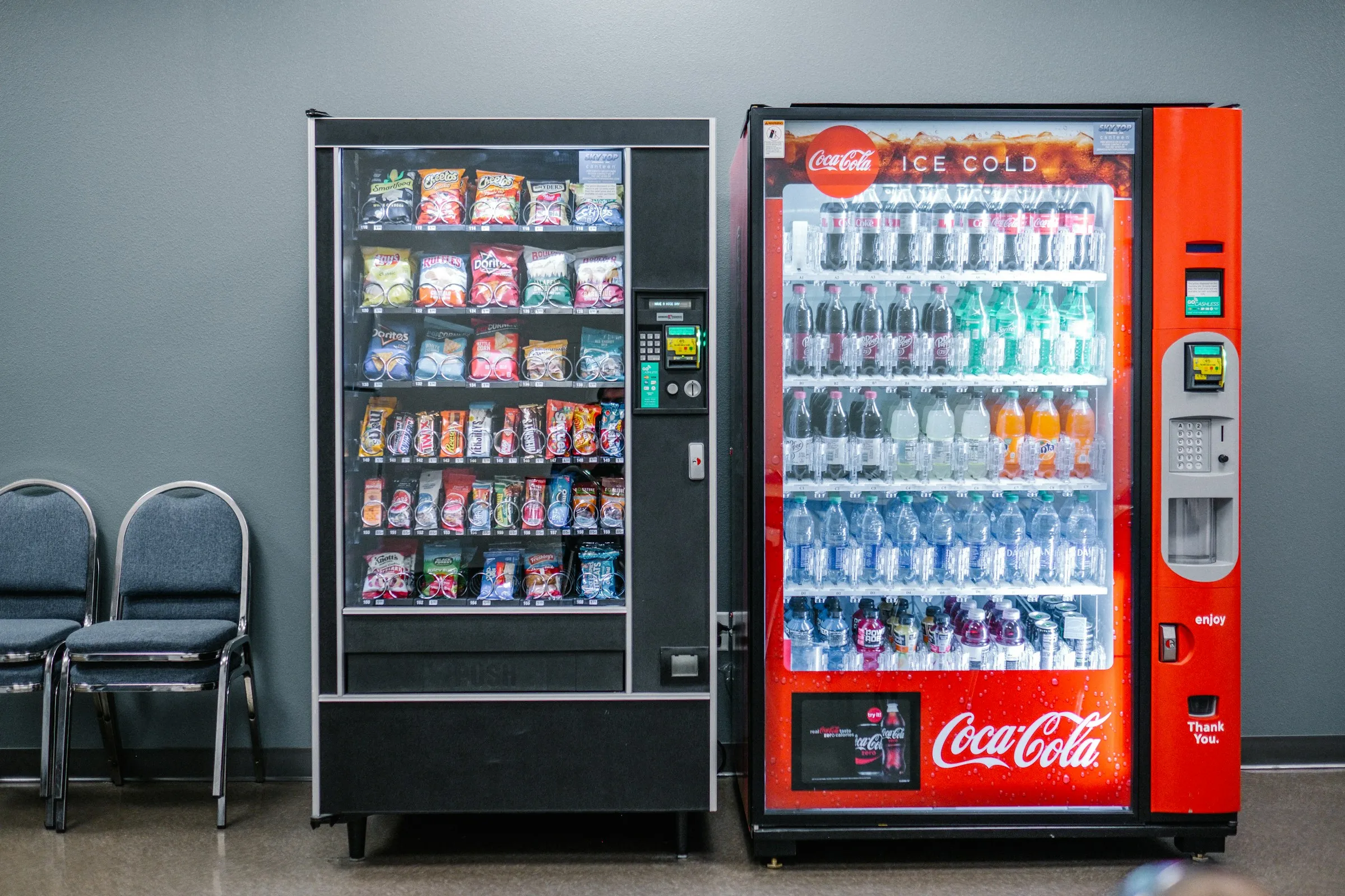 A snack vending machine and a drinks vending machine side by side. Illustrative photo, not MVend machines.