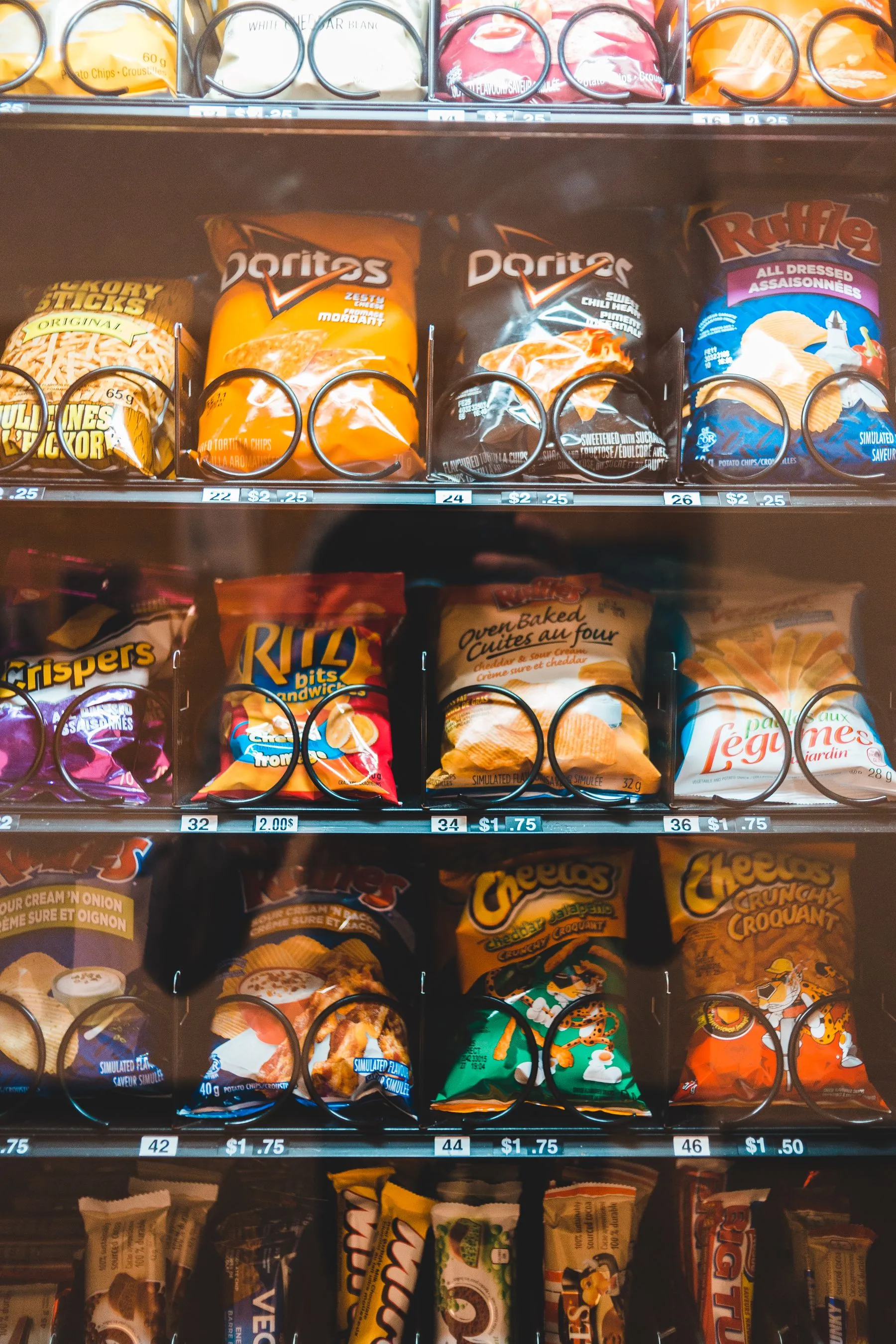 Bags of chips on the shelves of a vending machine